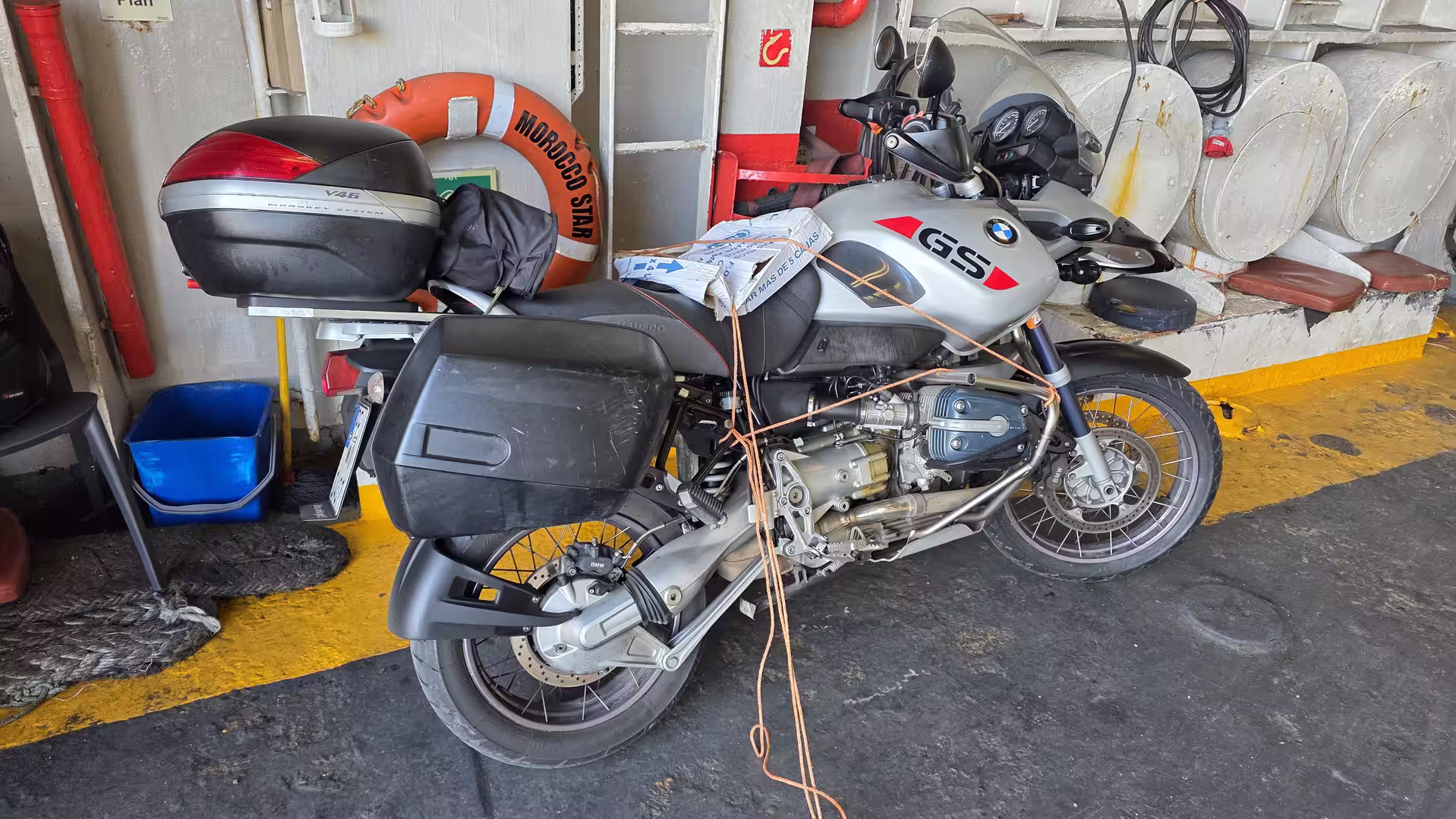BMW GS motorcycle secured on the ferry deck during the crossing between Spain and Morocco.