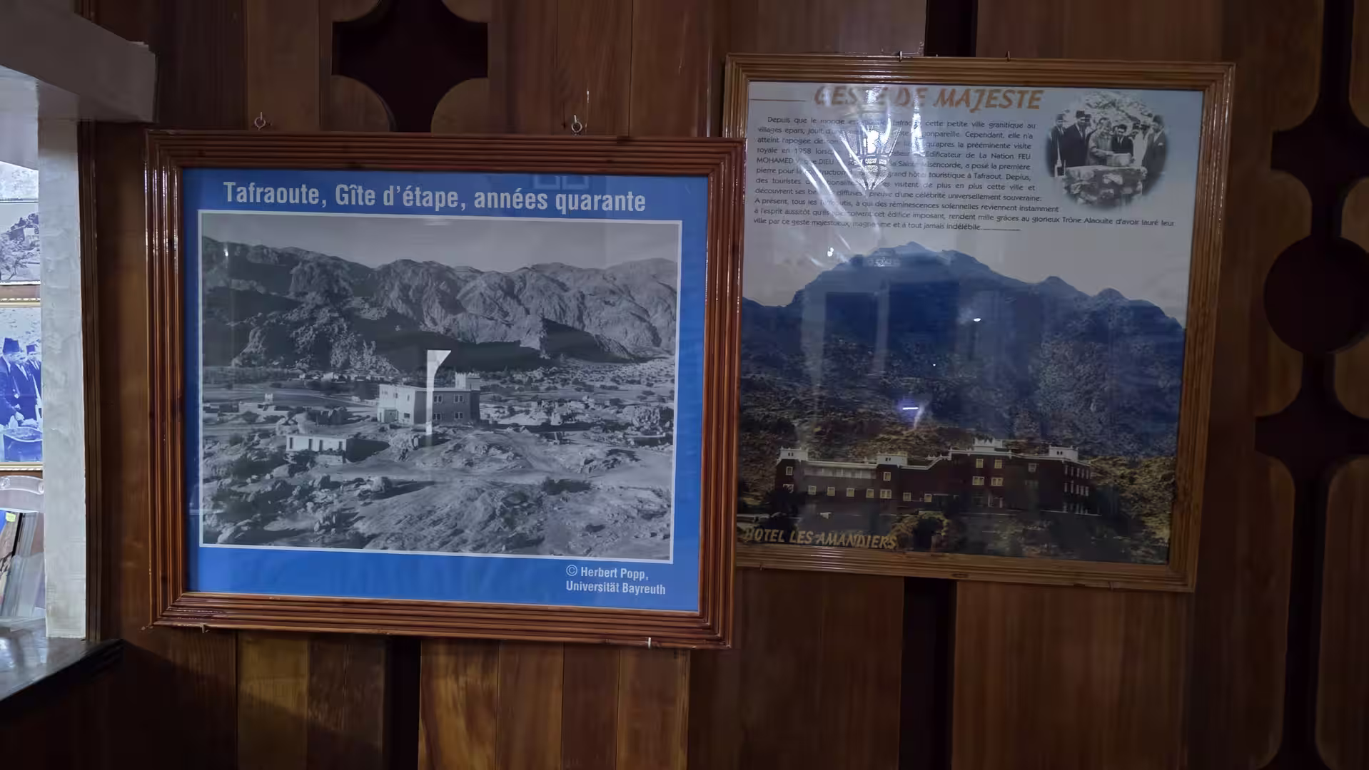 Historic photo displays in Tafraoute showing views of the town and surrounding mountains from different periods.