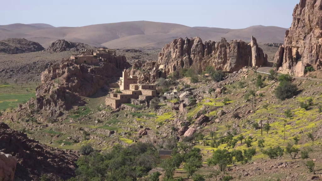 Mountain village and mosque nestled among dramatic granite rock formations in the Anti-Atlas.