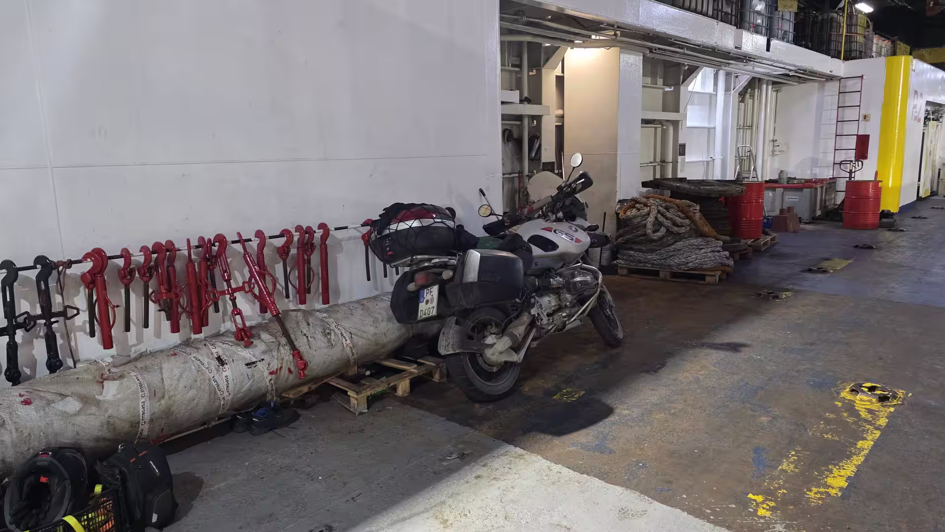 Loaded touring motorcycle secured inside a ferry vehicle deck during an overnight crossing between Morocco and Europe.