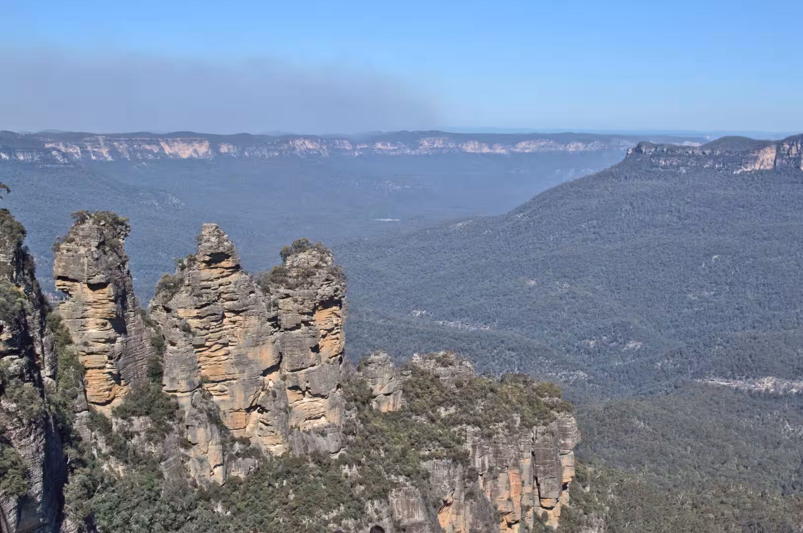 Three weathered rock spires stand like sentinels over the valley.