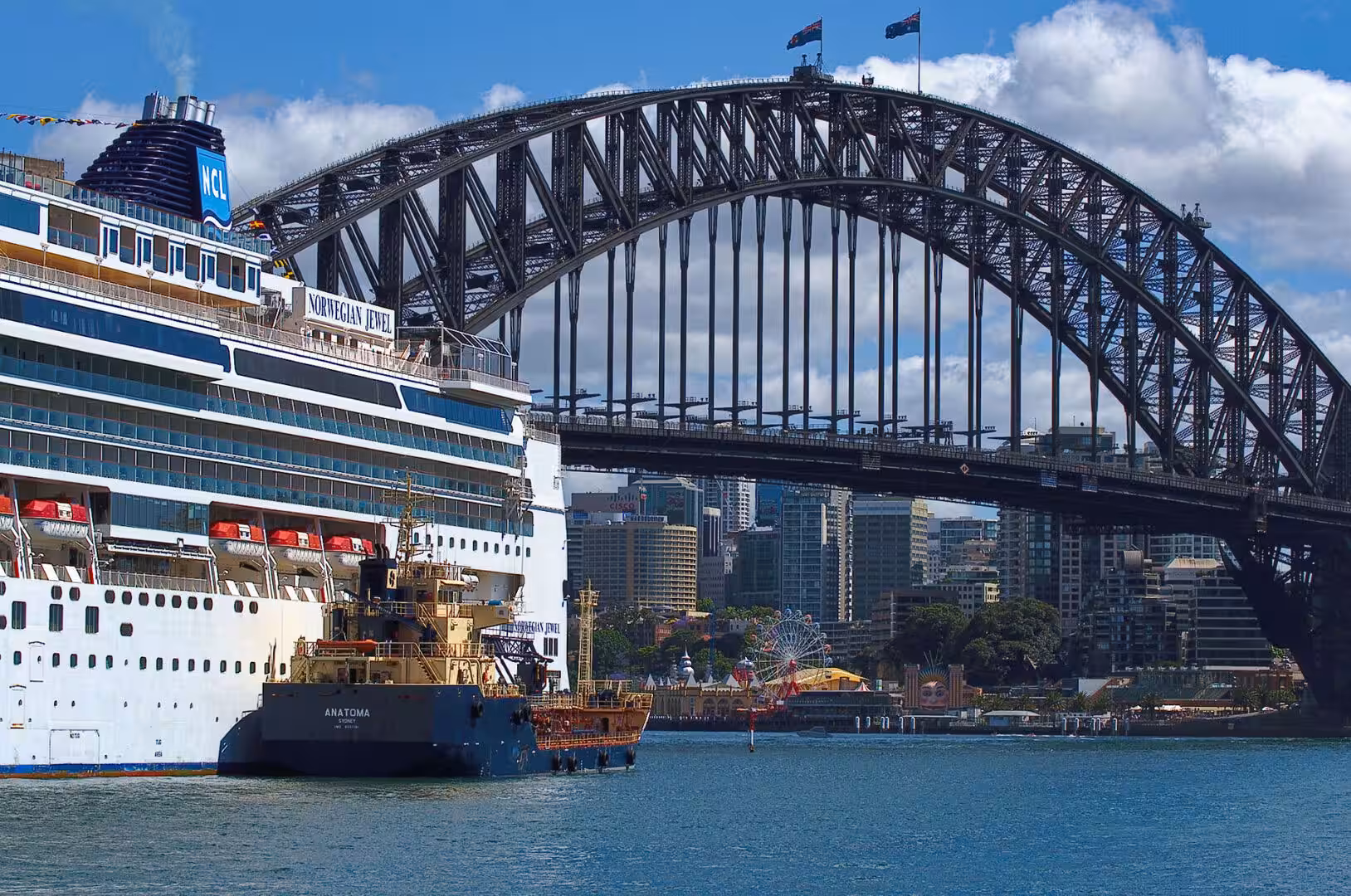 The Norwegian Jewel cruise ship sits beneath the great steel arch of the harbour bridge.