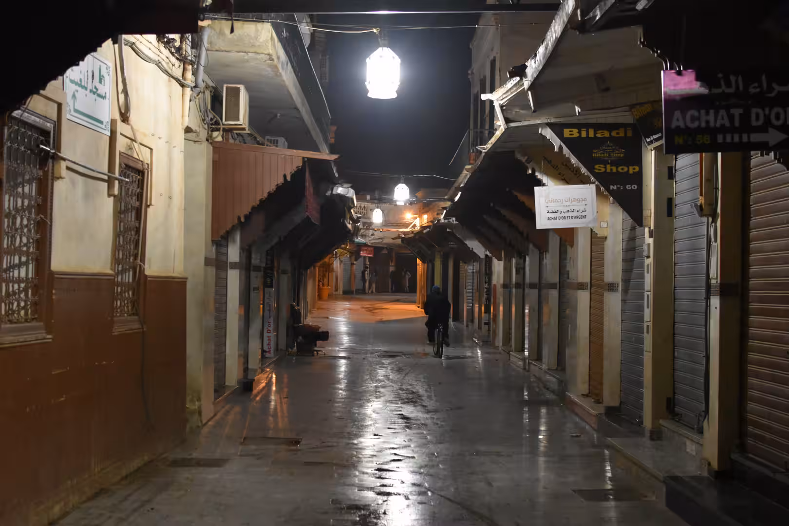Traditional market street illuminated by hanging lanterns in Oujda at night.