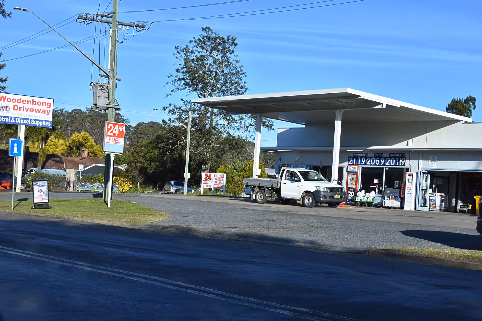 A small rural roadhouse offers petrol and diesel beneath a flat white canopy.